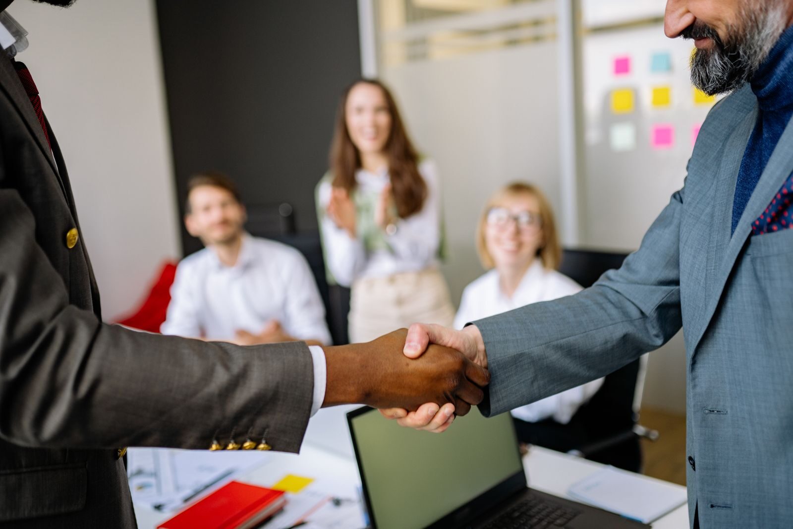 Business handshake after an independent tender process is agreed